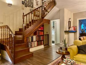 a living room with a staircase with bookshelves at B&B Balsimelli12 in San Marino