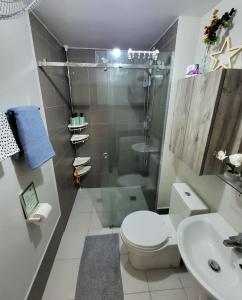 a bathroom with a shower and a toilet and a sink at Circulo Verde Avila North Tower in Manila