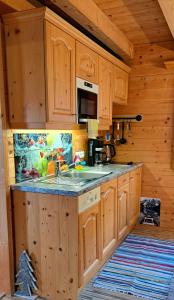 a kitchen with wooden cabinets and a sink in a cabin at Ferienhütten Zimmermann in Spital am Semmering