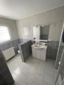 a bathroom with a sink and a mirror at Maison au sein d’un corps de ferme. in Carpiquet +7 photos