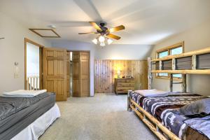 a bedroom with two beds and a ceiling fan at Swim, Hike, Relax Lakefront Hayward Home with Deck! in New Post