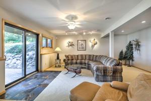 a living room with two couches and a large window at Swim, Hike, Relax Lakefront Hayward Home with Deck! in New Post