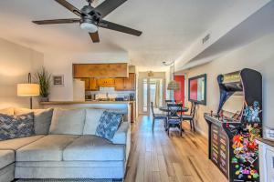 a living room with a couch and a kitchen at Condo with Pool Access - Walk to Beach! in Carolina Beach