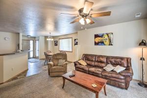 a living room with a couch and a ceiling fan at Cozy Sioux Falls House - Walk to Park! in Sioux Falls