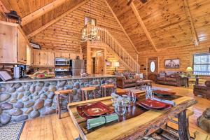 a dining room and living room in a log cabin at 'Sleeping Bear Cabin' Coosawattee! Dog Friendly! in Ellijay