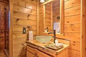 a bathroom with a sink in a log cabin at 'Sleeping Bear Cabin' Coosawattee! Dog Friendly! in Ellijay +19 photos
