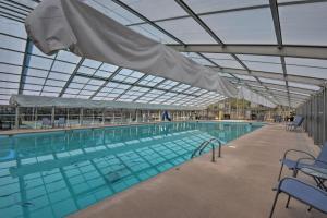 a large swimming pool with a glass ceiling at 'Sleeping Bear Cabin' Coosawattee! Dog Friendly! in Ellijay