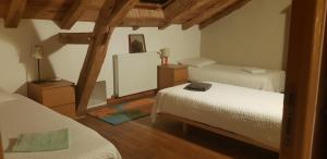 a bedroom with two twin beds and a mirror at Domaine de La Maison d'Aum in Bourrou +44 photos