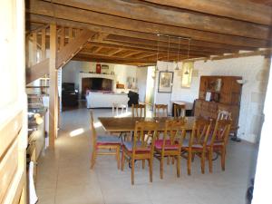 a kitchen and dining room with a table and chairs at Domaine de La Maison d'Aum in Bourrou