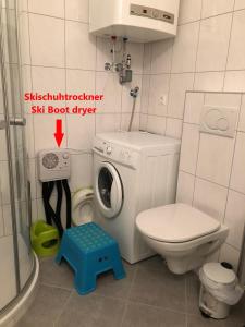 a bathroom with a washing machine and a toilet at Apartment HUGO in Bad Kleinkirchheim