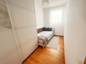 a small room with a couch and a window at Beach & Culture Barcelona Port Forum Penthouse Apartment in Sant Adria de Besos +32 photos