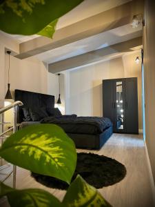 a bedroom with a bed and a large green pillow at Cosmopolis Forever Friday Luxury in Ştefăneştii de Jos