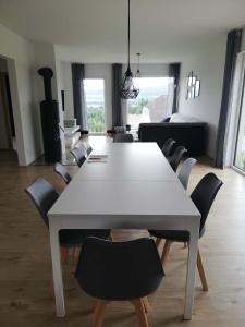 a dining room with a white table and chairs at Lipnohaus in Horní Planá