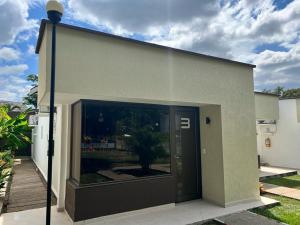 a building with a large glass door on it at Hotel TACALOA INN EXPERIENCE in Ricaurte