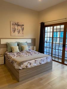 a bedroom with a bed and a large window at apartamento tenerife in Icod de los Vinos
