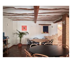 a dining room with tables and chairs and a plant at Casa Neleman in Casas del Rey