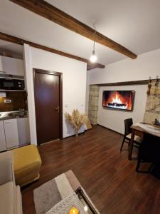 a living room with a couch and a fireplace at Holiday Old stone house in Sveti Ivan Zelina