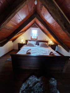 a bedroom with a large bed in an attic at Holiday Old stone house in Sveti Ivan Zelina