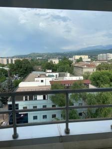 a view of a city from a balcony of a building at WhiteFort apartment in Almaty