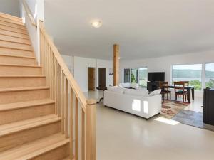 a living room with a white couch and a staircase at Auberge country inn in Baie-Saint-Paul