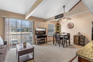a living room with a couch and a table with a tv at 2 Bed 2 Bath Fall Creek Condo in Branson