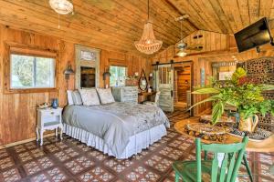 a bedroom with a bed in a room with wooden walls at Romantic Waterfront Getaway in Midway, GA! in Fancy Hall