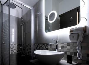 a bathroom with a sink and a mirror at Harbour Lounge rooms in Kardamaina