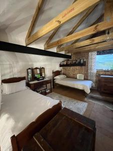 a large bedroom with two beds and a table at De Oude Mayde in Wilderness
