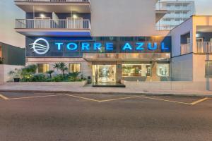 a store with a sign on the side of a building at Hotel Torre Azul & Spa - Adults Only in El Arenal