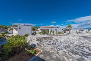 a house with a stone driveway in front of a building at More Exclusive Villas and Spa in Vir