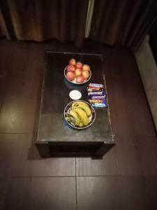 a table with two bowls of fruit and snacks on it at Chalets in Porto sharm rentals in Sharm El Sheikh