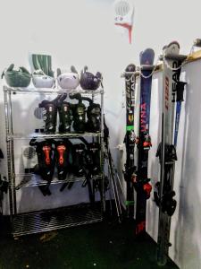 a rack with skis and ski equipment in a room at Gailtal Inn in Förolach