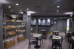 a restaurant with tables and chairs in a room at Carsson Hotel Downtown Buenos Aires in Buenos Aires