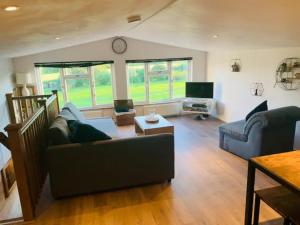 a living room with a couch and a table at Countryside Retreat Loft Apartment in Llancillo