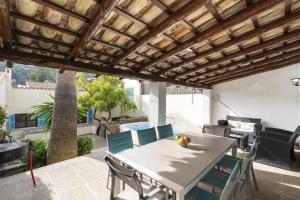 un patio con mesa y sillas en Can Cosset Holiday Home, en Capdepera