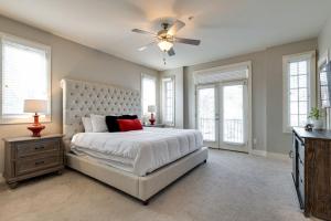 a bedroom with a large bed and a ceiling fan at Music Row Luxury Suites - Two King Bedrooms - Private Garage & Ensuite Baths in Nashville