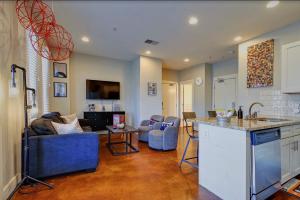 a kitchen and a living room with a couch and a table at Music Row Nashville King Beds Keyless Entry in Nashville