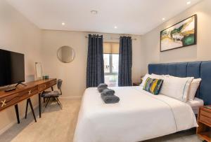 a bedroom with a bed and a desk and a television at York Central No 1, within the city walls, free parking in York