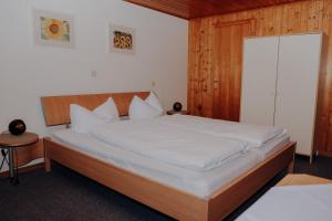 sypialnia z dużym łóżkiem z drewnianym zagłówkiem w obiekcie Schäfer Zita w mieście Fontanella