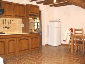 a kitchen with a refrigerator and a table and chairs at La Maison Tournesol - 3 bedroom house with large garden near Saumur in Saint-Martin-de-la-Place