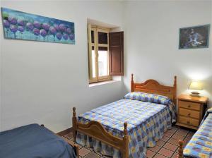 Łóżko lub łóżka w pokoju w obiekcie Casa Rural El Sendero
