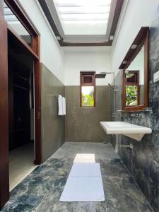 a bathroom with a sink and a mirror at Villa Ema in Galle