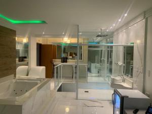 uma grande casa de banho com banheira e lavatório em Studio Motel (Adult Only) em Santos
