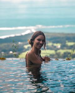 a woman in the water in a swimming pool at Vista Celestial in Uvita