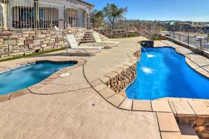 una piscina en un patio con una pared de piedra en Bullhead City Home with Private Pool, Hot Tub and View, en Bullhead City