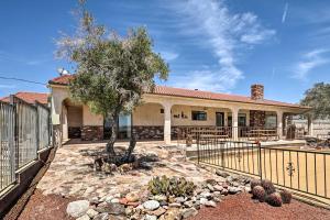 a house with a fence and a tree in a yard at Bullhead City Home with Private Pool, Hot Tub and View in Bullhead City