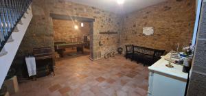 a room with a piano and a room with stone walls at Los Ríos - Sierra de Gata in Torre de Don Miguel