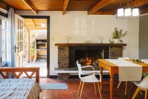 a living room with a table and a fireplace at Solar de amigos in Tandil