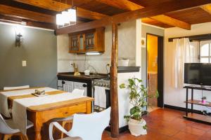 a kitchen and dining room with a table and chairs at Solar de amigos in Tandil +12 photos