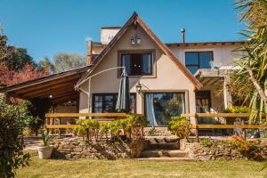 a house with an umbrella in front of it at Solar de amigos in Tandil